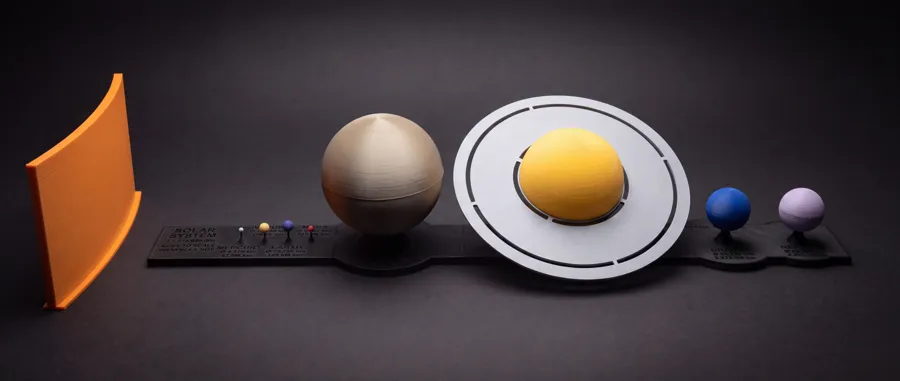 The assembled solar system model: an orange wall for the Sun, then the planets in a row.